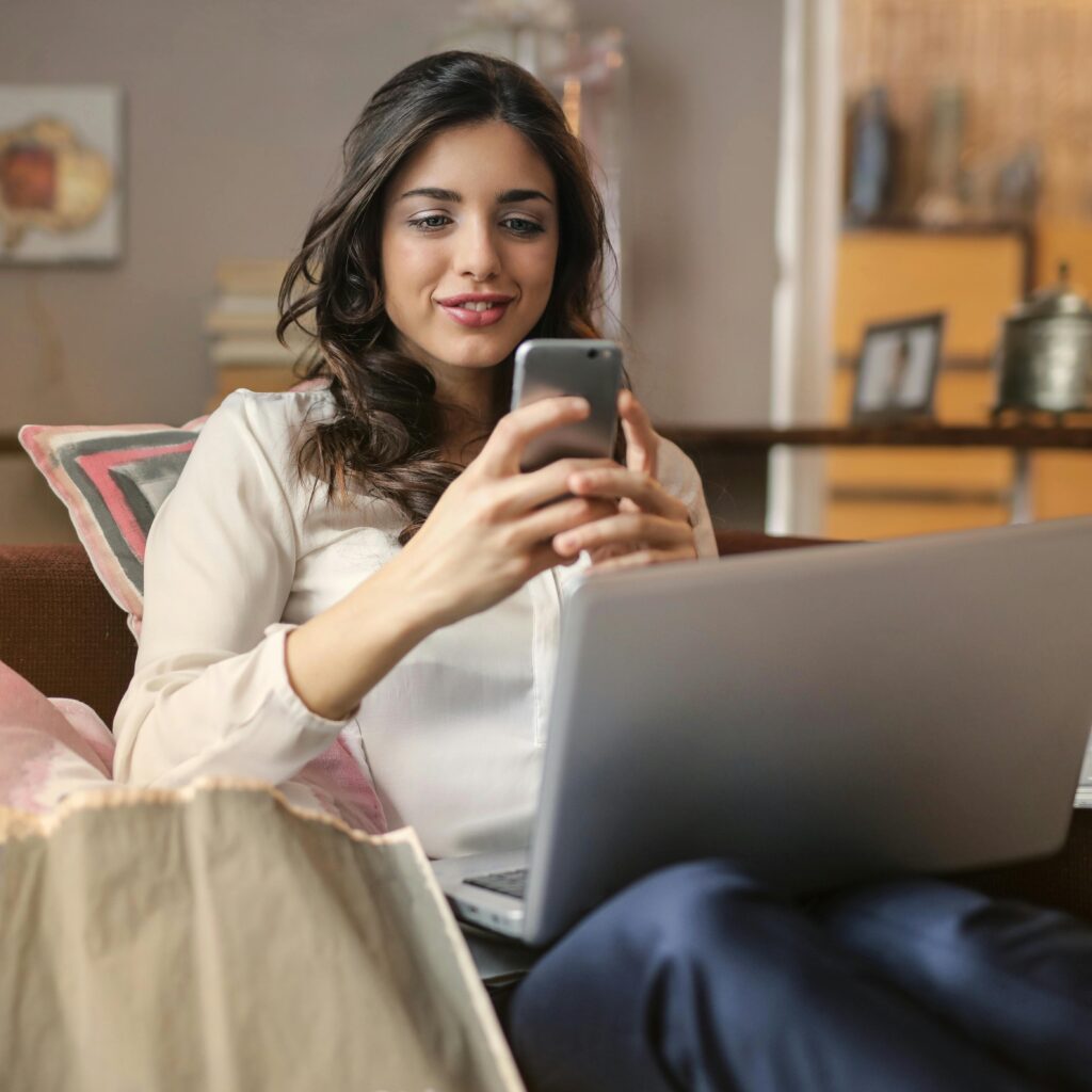 woman on the phone sitting on sofa