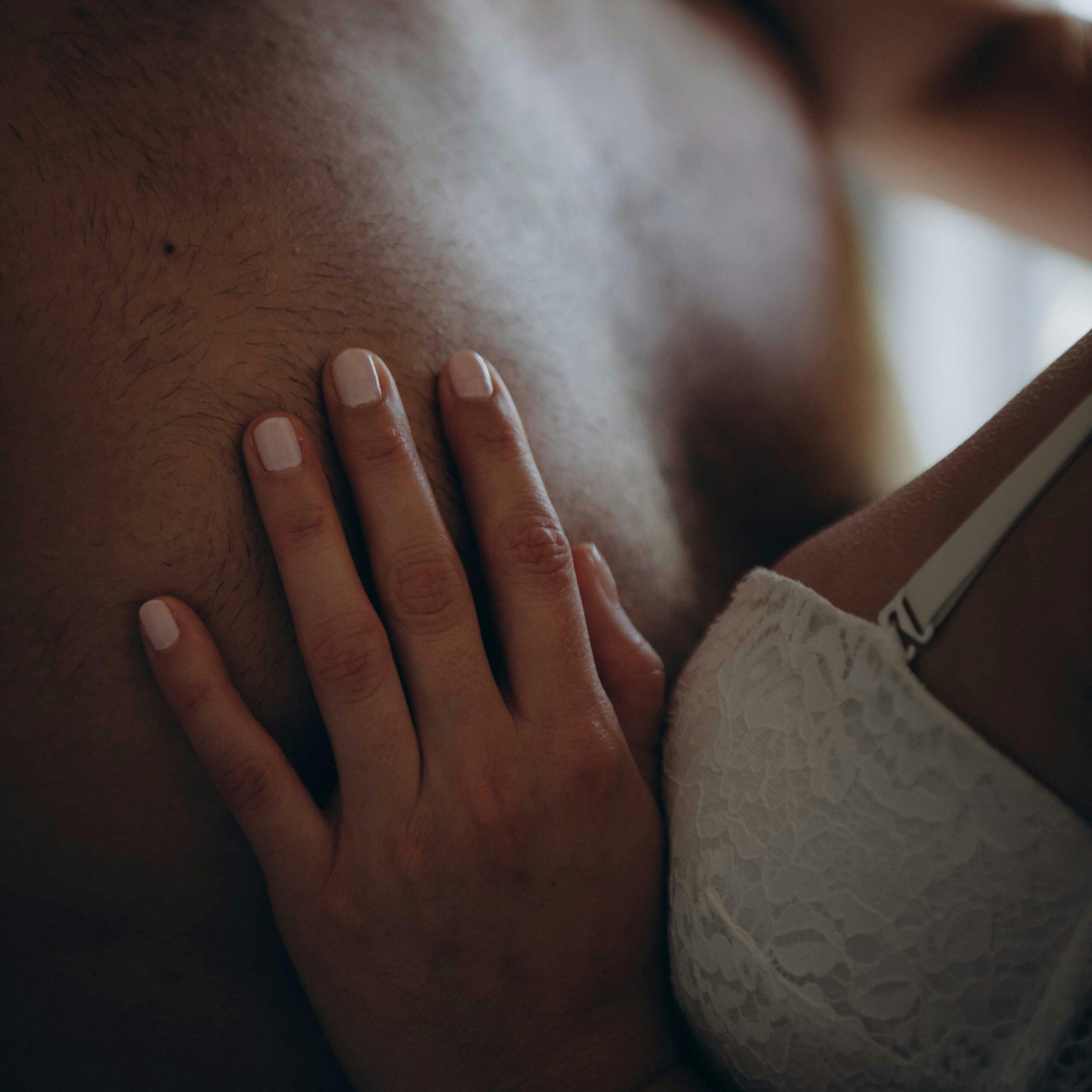 couple hugging while woman woman put hand on males chest scaled