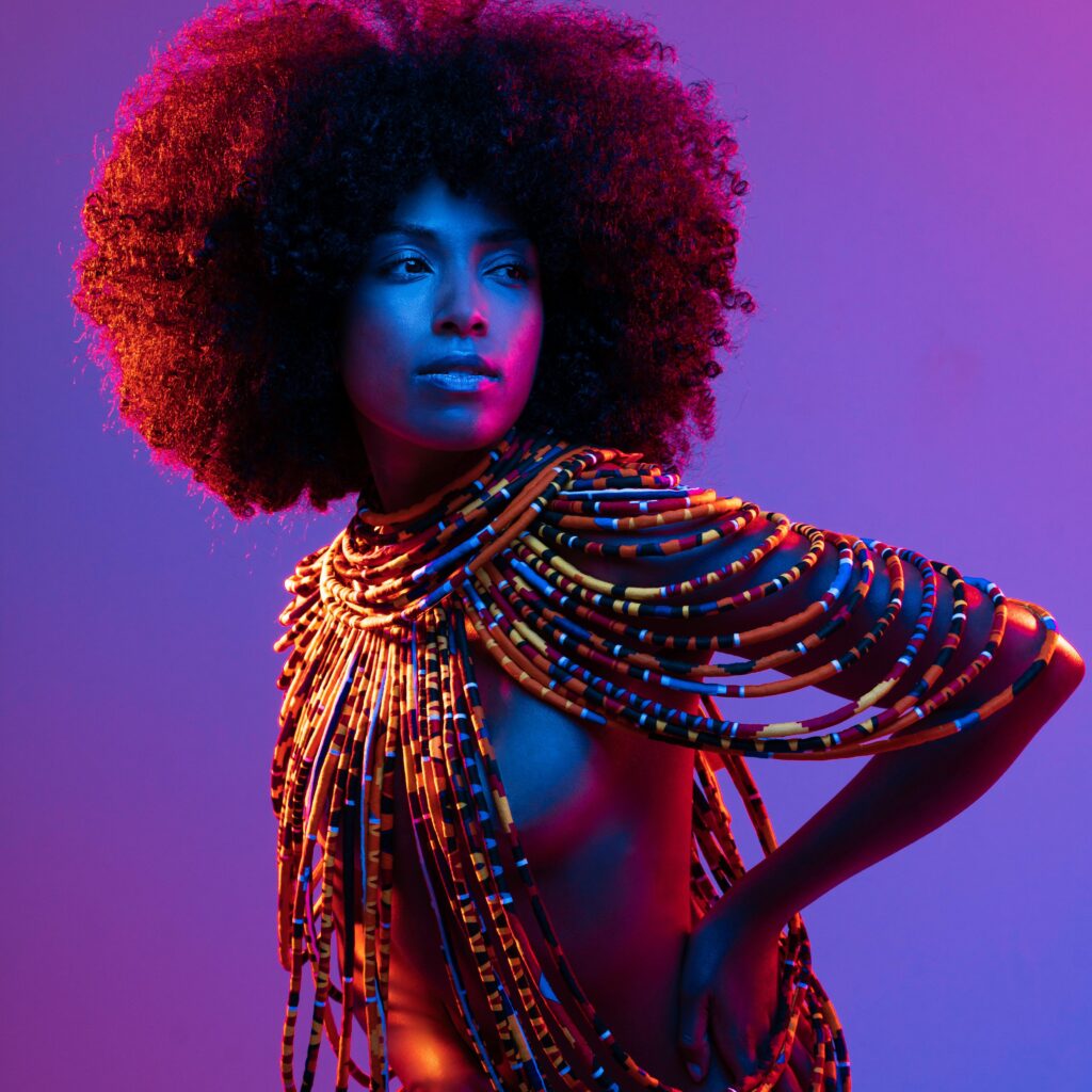 black woman posing in neon light - CreatorTraffic.com