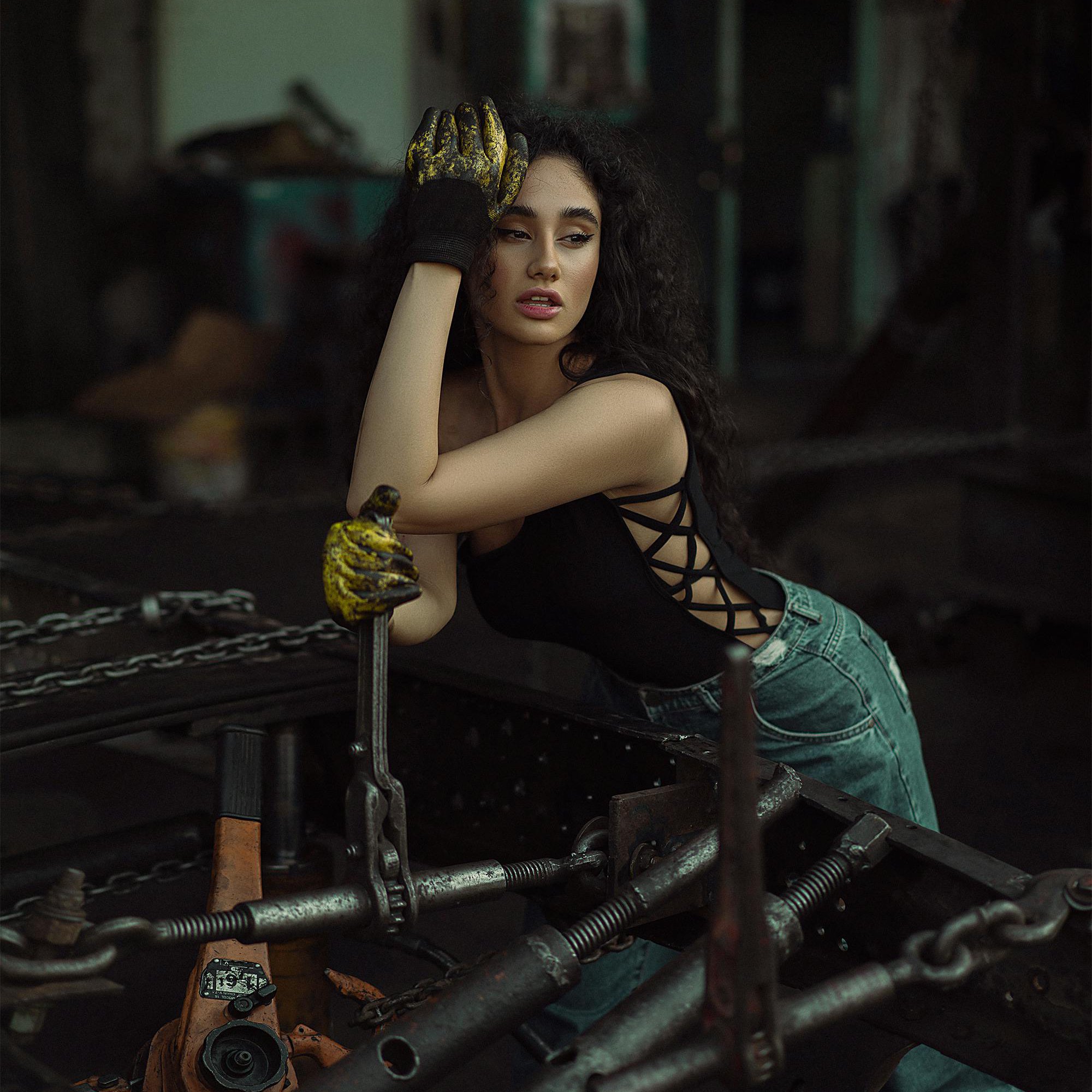 woman with locks posing as mechanic